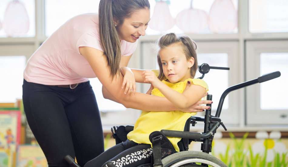 Physical Therapist Helping a Student in a Wheelchair